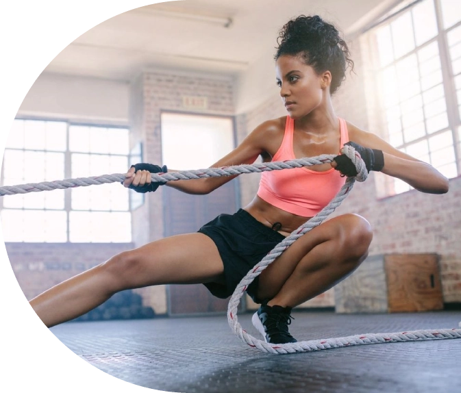 A woman is using ropes to work out