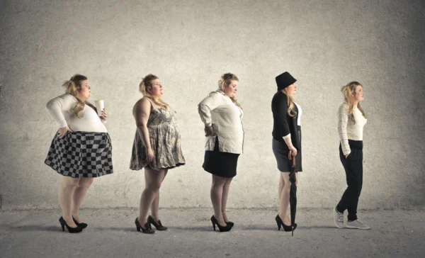 A line of women in different outfits and sizes.